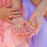 Children wearing the Lauren Hinkley besties charm bracelets