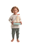 Child with wooden Sailaway boat by Tender Leaf toys