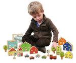 Child playing with the Wooden Village to show the scale of the pieces