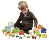 Child playing with the Wooden Village to show the scale of the pieces