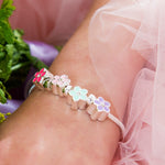 Child wearing Lauren Hinkley Bouquet charm bracelet